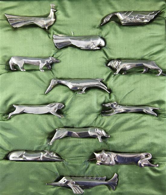 A cased set of twelve silvered bronze cubist knife rests by Galia, 4in et infra.